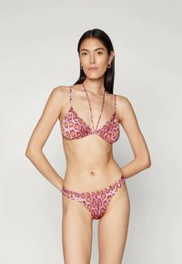 Leopard print bikini set featuring a pink base, triangle bralette with thin straps, and matching side-tie bottoms. Smooth texture and minimal coverage.