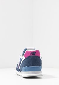 Marina mockasiner i mocka med rosa och vita detaljer, med en vadderad häl och texturerad yta. Inkluderar logotypdetalj på baksidan.