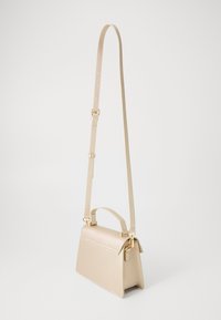 Beige leather crossbody bag with a structured shape, top handle, and adjustable strap; features a smooth texture and gold hardware accents.