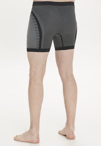 Svarta och grårandiga boxershorts med en tight passform, elastisk midjeband och textil med struktur. Har en sömlös konstruktion.