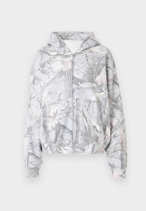 Kapuzensweatshirt mit Reißverschluss in Grau mit einem Muster aus Baumzweigen und Blättern. Verfügt über Taschen vorne und elastische Bündchen. Weiche Stofftextur.