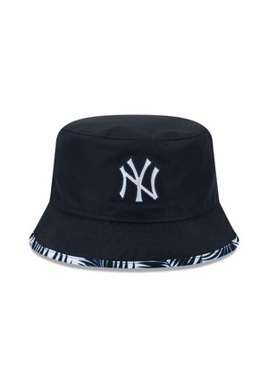 Navy bucket hat with white New York Yankees logo and black-and-white patterned brim edge.
