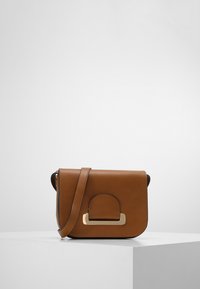Brun læder crossover taske med en struktureret design, guldfarvede detaljer og lukning med frontklap. Glat tekstur og justerbar strop.