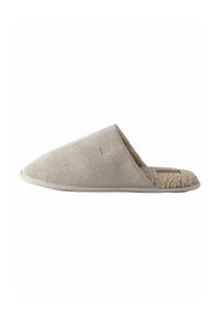 Beige Slipper ohne Schnürung mit strukturiertem, gewebtem Außenmaterial und weichem, flauschigem Innenfutter; runde Zehenform und flache Sohle.