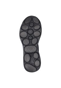 De zool van de schoen heeft een gestructureerd zwart rubber ontwerp met cirkelvormige en ovale patronen voor grip, met variërende oppervlakte dieptes en texturen.