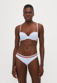 Light blue bikini with padded bra and matching bottoms. Features horizontal red and white stripes on the waistband. Smooth texture.