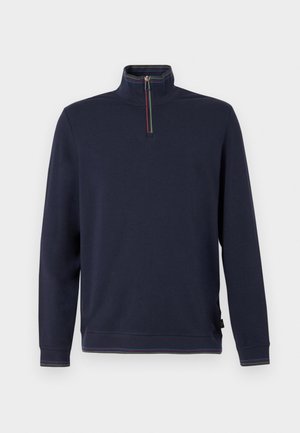 Felpa blu navy con colletto alto e chiusura con mezza zip. Presenta un bordo a righe multicolore intorno al collo e all'orlo. Tessuto morbido in misto cotone.