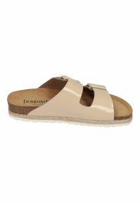 Beige patent leather slide sandals with two adjustable buckles, cork footbed, jute detailing, and a white rubber sole.