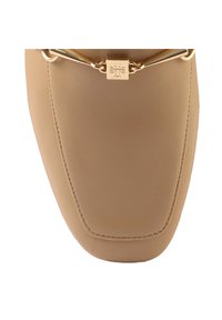 Beige faux leather flat shoe with a pointed toe, featuring a gold chain accent and a square metal logo detail on the upper.