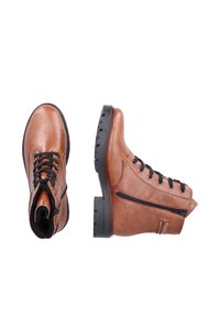 Bottes de cheville en cuir marron avec des lacets noirs, fermeture éclair sur le côté et semelle en caoutchouc texturée. Présente une finition lisse et des détails de couture décoratifs.