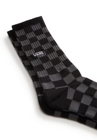 Schwarz-graue Schachbrettsocken mit gerippten Bündchen, versehen mit dem weißen Vans-Logo. Weiches Strickmaterial mit mittlerer dicke.