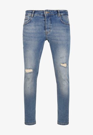 Jeans skinny de mezclilla azul con detalles desgastados, que incluyen desgastes en las rodillas, diseño de cinco bolsillos y una cinturilla estándar con cierre de botón.