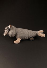 Soft grey plush toy shaped like a seal, with tan flippers and a textured body. Features a furry, dark mane and a flat tail.