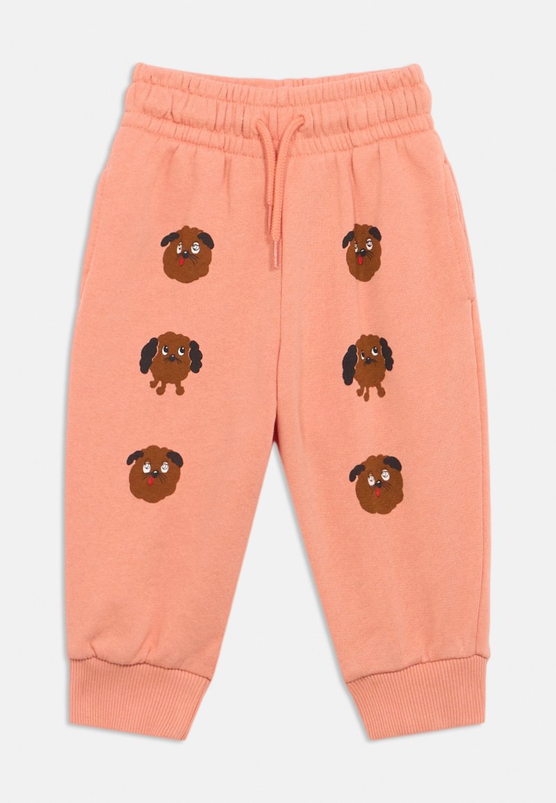 Pantaloni della tuta rosa con vita elastica. Presentano diversi volti di cani cartoon ricamati in marrone e nero. Orli alle caviglie a coste.