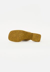 Brown rubber shoe sole with an embossed flower design and "CAMPPER" text. Square heel with a flat bottom, size 38 indicated.