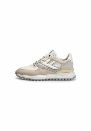 Sneakers with a beige and gray leather upper, white accents, padded tongue, and textured sole with circular grips for traction.