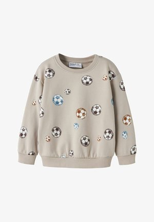 Otroški bež pulover z večbarvnimi vzorci nogometne žoge, raztresenimi po tkanini, z rebrastim ovratnikom, manšetami in spodnjim robom.