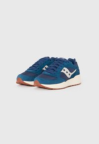 Pair of blue and navy athletic sneakers with white side logos, white midsoles, and brown outsoles on a plain light background.