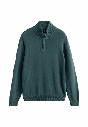 Roheline pikavarrukaga kudum, millel on sooniline poollukk krae ning soonilised varrukasääred ja alumine serv, mis annavad istuva lõppviimistluse.