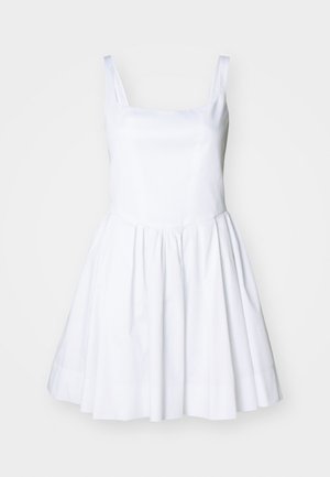 White dress with a square neckline and thin straps. The bodice is fitted, leading to a flared skirt with a smooth texture and no visible patterns.
