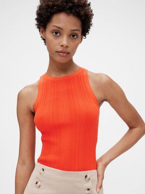 Ribbed orange sleeveless top with a high neckline, paired with a beige skirt featuring button accents. Smooth texture, fitted design.