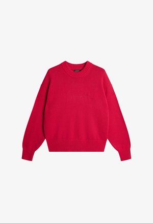 Maglione rosso lavorato a maglia con scollo rotondo, spalle scese e polsini e orlo a costine. Presenta un logo discreto sul davanti.