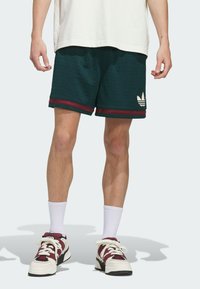 Dark green athletic shorts with a textured mesh design, featuring maroon accents at the hem and a white Adidas logo on the side.