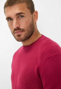Maglione a girocollo di un vivace colore lampone, con un motivo a maglia testurizzato, design aderente e cuciture delle spalle visibili.