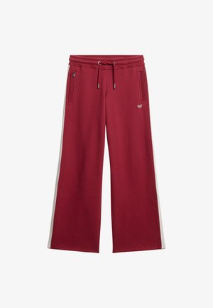 Wijdvallende sweatpants in bordeauxrode stof met lichtgrijze zijstrepen, elastische tailleband met trekkoord en twee voorkruiszakken.