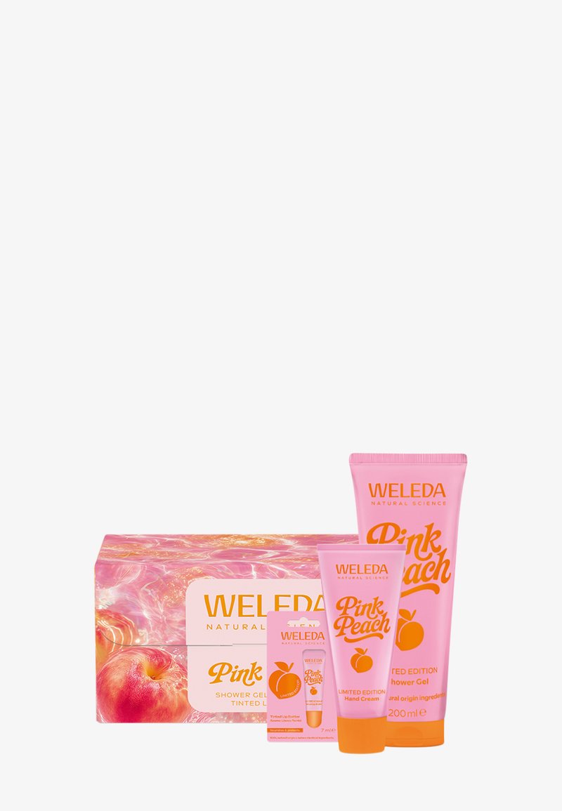 Pink Peach limited edition Weleda set with tinted lip balm, hand cream, and shower gel in pink and orange packaging.