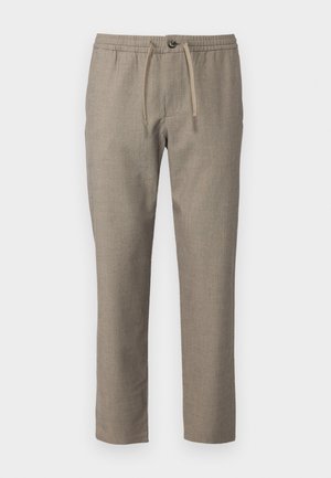 Pantalons beiges avec une taille élastique, fermeture à cordon de serrage et une coupe droite. Le matériau a une texture subtile.
