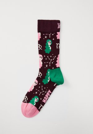 Chaussette violette seule avec un talon vert, un orteil rose, ornée de visages illustrés avec des cheveux verts et roses, des symboles du zodiaque, et le mot "HEUREUX".