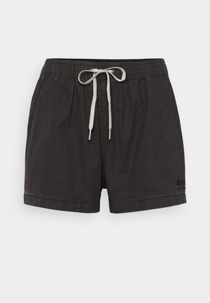 Black shorts with an elastic waistband and contrasting white drawstring. Made of lightweight fabric, featuring a small logo detail on the side.