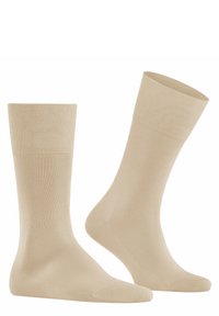 Calcetines de algodón beige tipo crew con puños acanalados, textura suave, puntera y talón reforzados, y una forma clásica para mayor comodidad y ajuste.