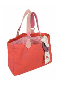 Sac fourre-tout en tissu corail avec des poignées en daim rose, doublure intérieure à pois et étiquette décorative avec une image de profil et des accents frangés.