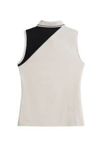 Ärmlös polo skjorta i ljus beige med en svart sned design vid axeln. Har en kontrasterande krage med vit kant. Slät textur.