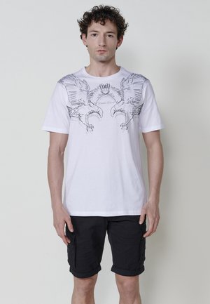 White cotton t-shirt with a black graphic of two eagles on the chest, crew neckline, short sleeves, and a relaxed fit.