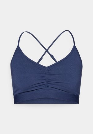 Navy blue bralette with a ruched front, dual thin straps crisscrossed at the back, and a smooth elastic band at the bottom.