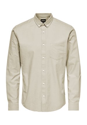 Chemise beige à manches longues avec boutons, col boutonné et poche poitrine, affichée de face sur fond blanc.