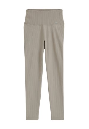 Leggings en beige claro de cintura alta con tejido acanalado, una cinturilla ancha y ajuste ceñido, mostrados planos sobre un fondo blanco.