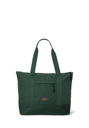 Mørkegrøn mulepose med lange håndtag, frontlomme med lynlås og lille rektangulært Timberland-logo midt på lommen.