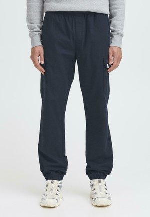 Navy blue cargo pants with an elastic waistband, side pockets, and elastic cuffs, made from a soft, lightweight fabric.