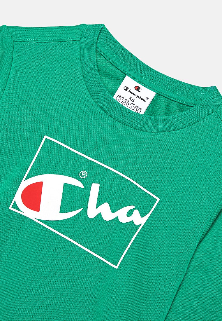 Sweatshirt en coton vert avec un logo blanc et des accents rouges. Encolure ronde et tissu texturé, étiqueté en taille XS.