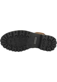 Semelle de botte en cuir marron avec un motif de profondeur, construction en caoutchouc noir, et logo embossé sur le côté. Adhérence texturée pour traction.