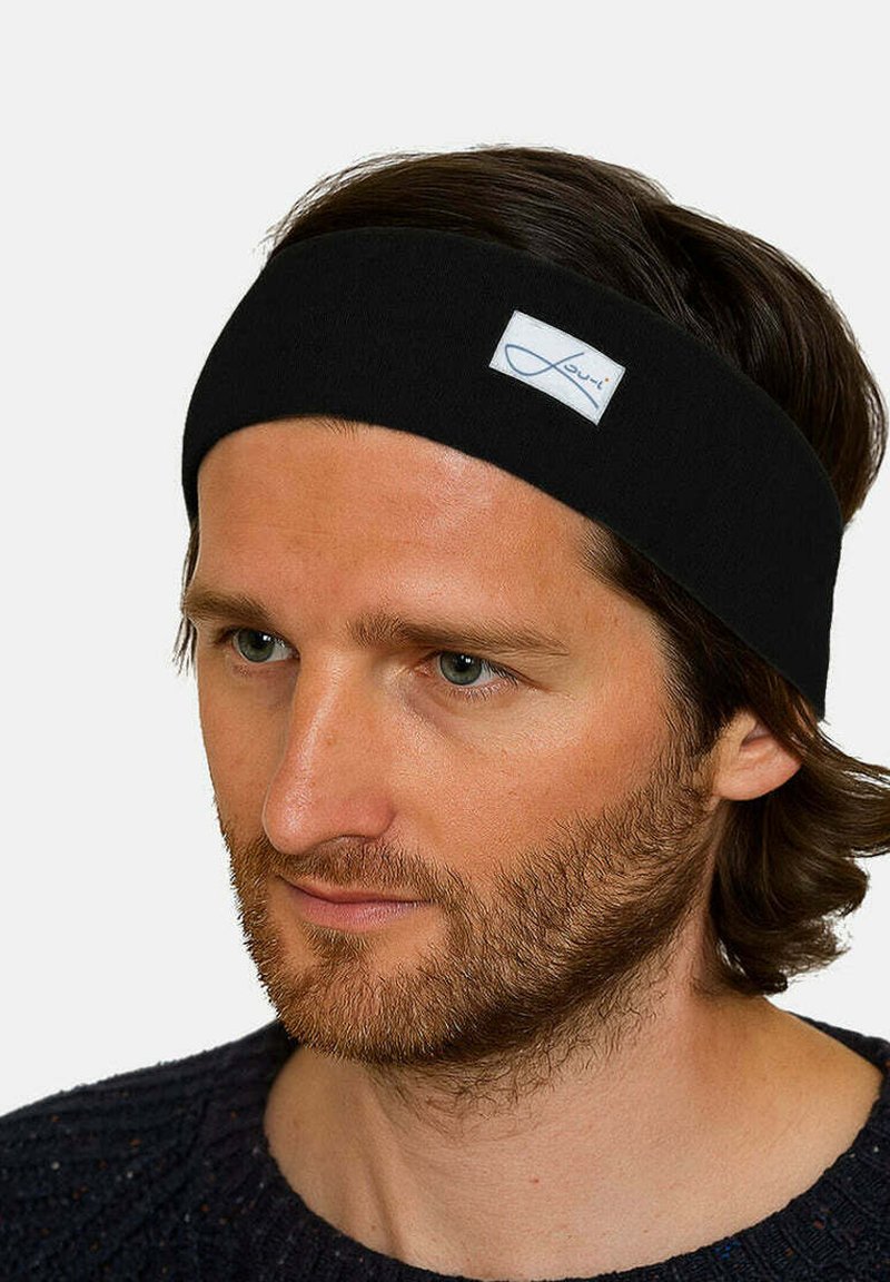Black fabric headband featuring a rectangular white label with blue text. It has a smooth texture and a simple, elongated design.
