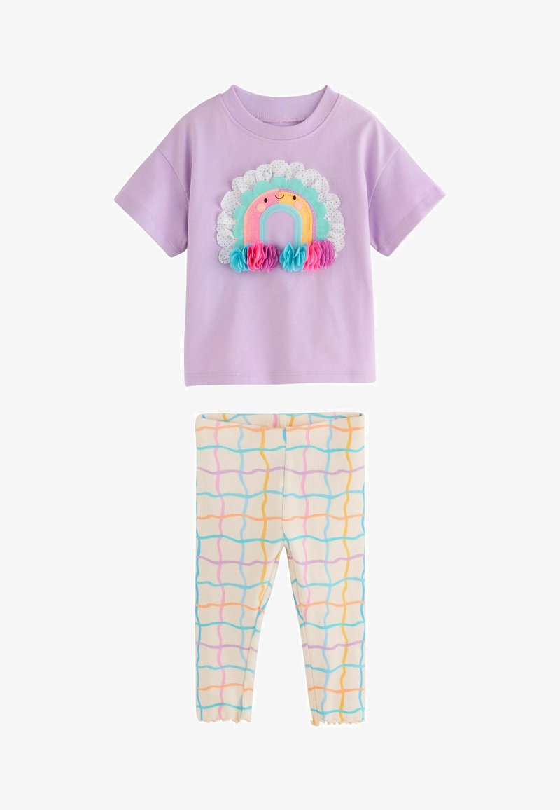 Lilac short-sleeve shirt with a smiling rainbow and fabric flowers paired with cream leggings featuring colorful wavy grid lines.