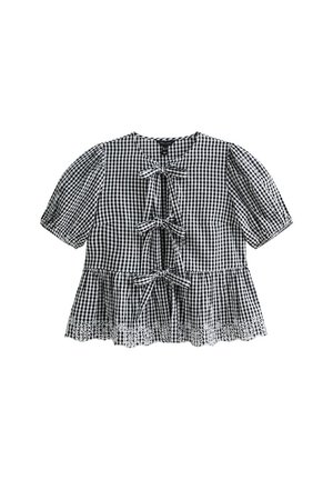 Blouse à carreaux noir et blanc avec des manches courtes à volants, trois liens à l'avant et une bordure en dentelle sur l'ourlet. Tissu en coton, coupe décontractée.