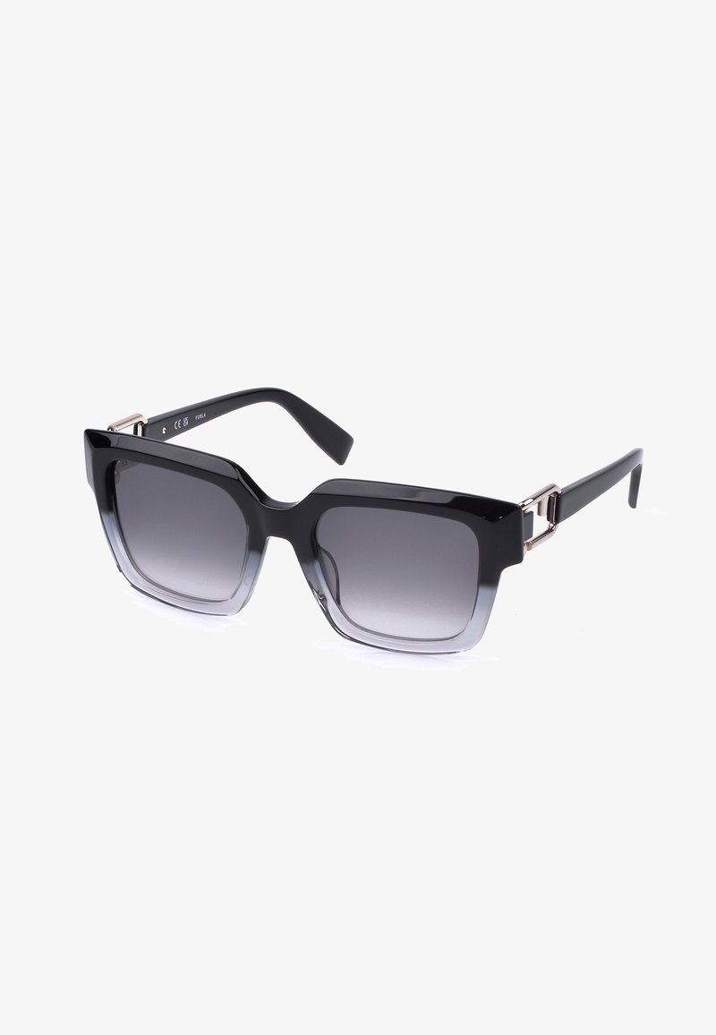 Lunettes de soleil carrées noires surdimensionnées avec verres gris dégradés et charnières métalliques décoratives sur les branches.