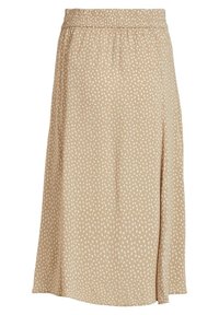 Jupe midi en tissu beige avec une texture douce, arborant un motif de points abstraits blancs et une taille élastique pour le confort.