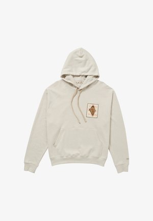 Sweat à capuche beige avec poche kangourou à l'avant et petite écusson carré comportant un visage de style vintage et du texte sur la poitrine.